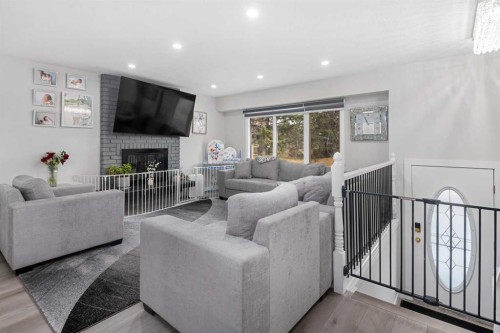 255 Rundleridge Drive Ne, Calgary, AB - Indoor Photo Showing Living Room With Fireplace