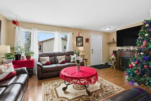 1207 Olympia Drive Se, Calgary, AB - Indoor Photo Showing Living Room With Fireplace