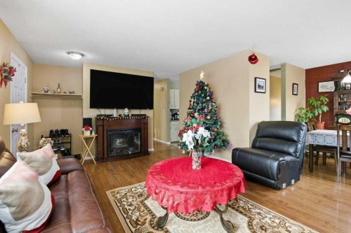 1207 Olympia Drive Se, Calgary, AB - Indoor Photo Showing Living Room With Fireplace