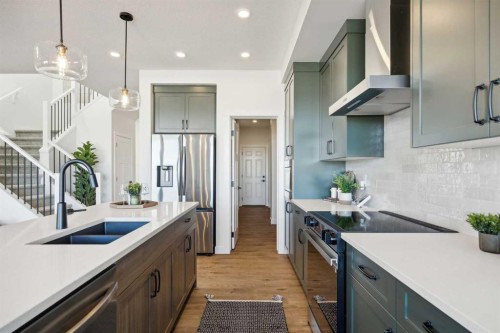213 Southbow Drive, Cochrane, AB - Indoor Photo Showing Kitchen With Double Sink With Upgraded Kitchen