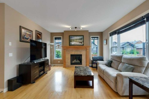 200 Cimarron Drive, Okotoks, AB - Indoor Photo Showing Living Room With Fireplace