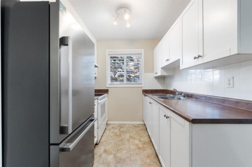 1102-2395 Eversyde Avenue Sw, Calgary, AB - Indoor Photo Showing Kitchen With Double Sink