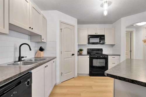 101-120 Panatella Landing Nw, Calgary, AB - Indoor Photo Showing Kitchen With Double Sink