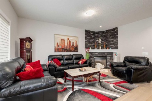 163 Cougarstone Court Sw, Calgary, AB - Indoor Photo Showing Living Room With Fireplace