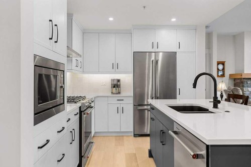107-1315 Spring Creek Gate, Canmore, AB - Indoor Photo Showing Kitchen With Stainless Steel Kitchen With Double Sink With Upgraded Kitchen