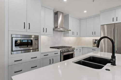 107-1315 Spring Creek Gate, Canmore, AB - Indoor Photo Showing Kitchen With Stainless Steel Kitchen With Double Sink With Upgraded Kitchen