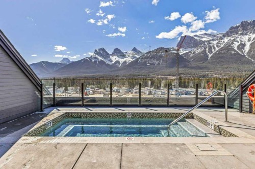 107-1315 Spring Creek Gate, Canmore, AB - Outdoor With In Ground Pool With View