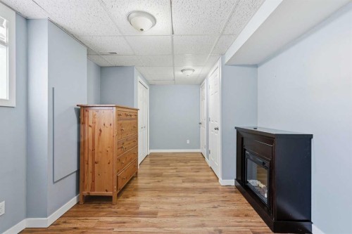 2 Woodfern Road Sw, Calgary, AB - Indoor Photo Showing Other Room With Fireplace