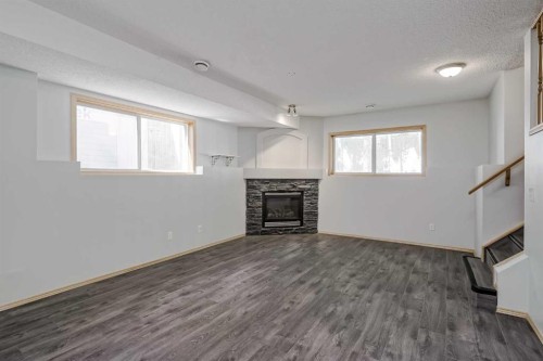 31 Panatella Drive Nw, Calgary, AB - Indoor Photo Showing Other Room With Fireplace