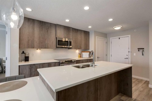 412-8531 8A Avenue Sw, Calgary, AB - Indoor Photo Showing Kitchen With Double Sink With Upgraded Kitchen