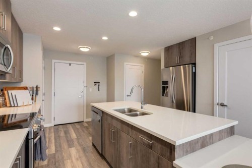412-8531 8A Avenue Sw, Calgary, AB - Indoor Photo Showing Kitchen With Stainless Steel Kitchen With Double Sink