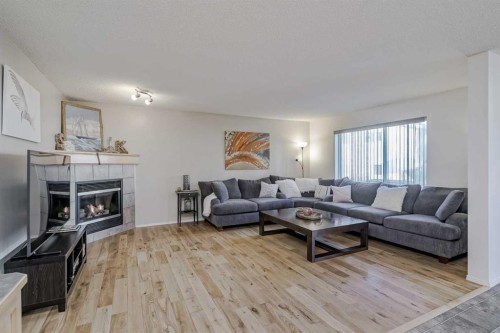 212 Cove Court, Chestermere, AB - Indoor Photo Showing Living Room With Fireplace