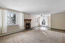 3211-80 Glamis Drive Sw, Calgary, AB  - Indoor Photo Showing Living Room With Fireplace 
