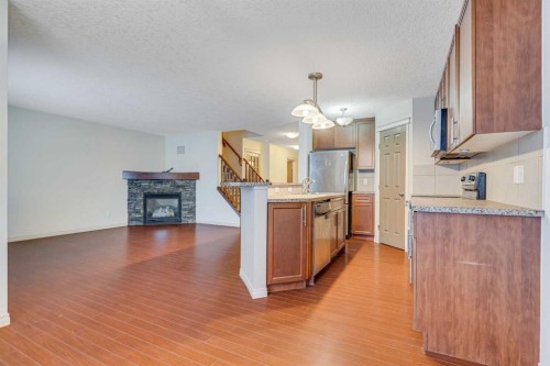 113 Cimarron Grove Close, Okotoks, AB - Indoor Photo Showing Other Room With Fireplace
