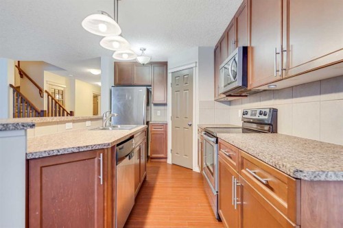 113 Cimarron Grove Close, Okotoks, AB - Indoor Photo Showing Kitchen With Double Sink