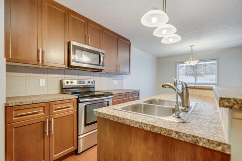 113 Cimarron Grove Close, Okotoks, AB - Indoor Photo Showing Kitchen With Double Sink