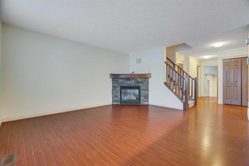 113 Cimarron Grove Close, Okotoks, AB - Indoor Photo Showing Living Room With Fireplace