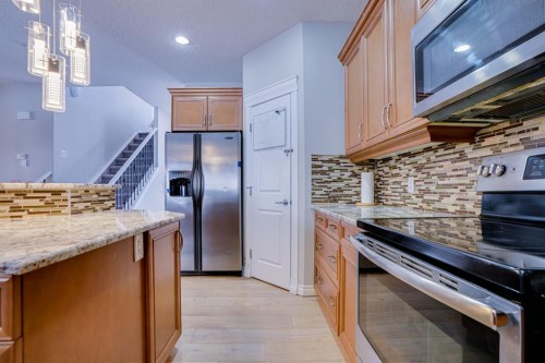 77 Saddleland Drive Ne, Calgary, AB - Indoor Photo Showing Kitchen With Upgraded Kitchen