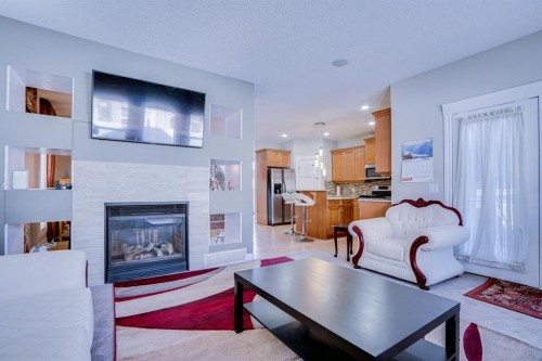 77 Saddleland Drive Ne, Calgary, AB - Indoor Photo Showing Living Room With Fireplace