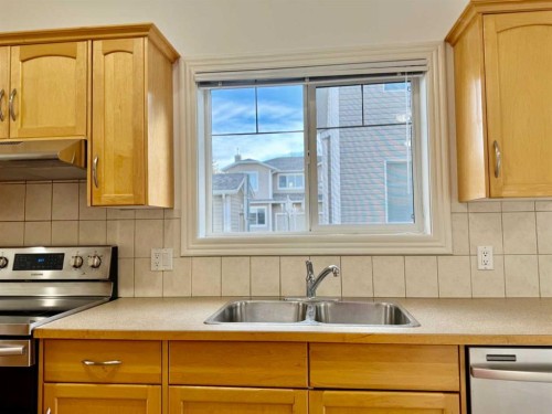 17 Bridleridge Manor Sw, Calgary, AB - Indoor Photo Showing Kitchen With Double Sink