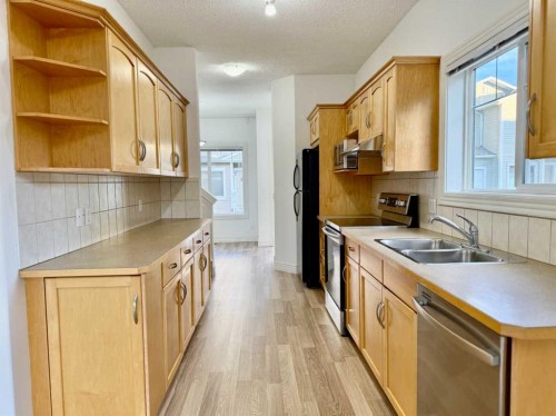 17 Bridleridge Manor Sw, Calgary, AB - Indoor Photo Showing Kitchen With Double Sink