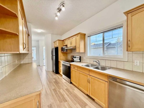 17 Bridleridge Manor Sw, Calgary, AB - Indoor Photo Showing Kitchen With Double Sink