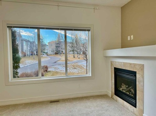 17 Bridleridge Manor Sw, Calgary, AB - Indoor Photo Showing Other Room With Fireplace