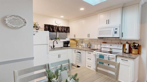 5092 51 Avenue, Stavely, AB - Indoor Photo Showing Kitchen With Double Sink