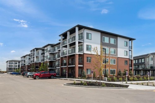 2210-6 Merganser Drive West, Chestermere, AB - Outdoor With Balcony With Facade