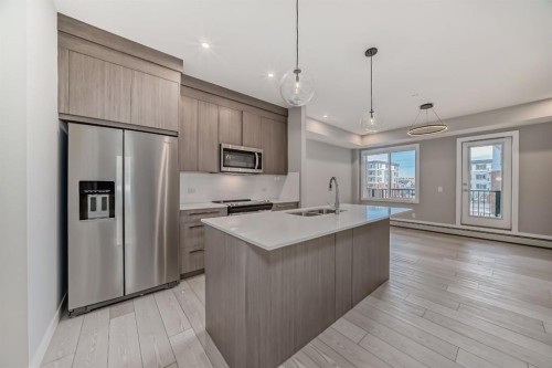 1218-6 Merganser Drive West, Chestermere, AB - Indoor Photo Showing Kitchen With Stainless Steel Kitchen With Double Sink With Upgraded Kitchen