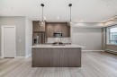 1218-6 Merganser Drive West, Chestermere, AB  - Indoor Photo Showing Kitchen With Double Sink With Upgraded Kitchen 