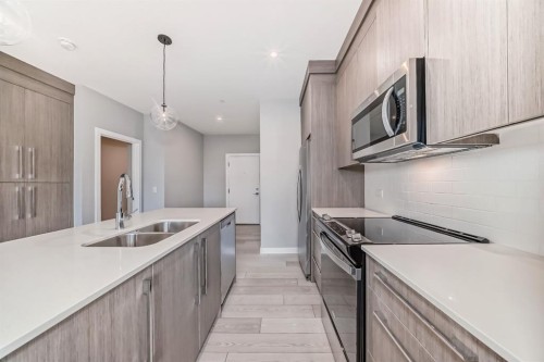 1218-6 Merganser Drive West, Chestermere, AB - Indoor Photo Showing Kitchen With Double Sink With Upgraded Kitchen
