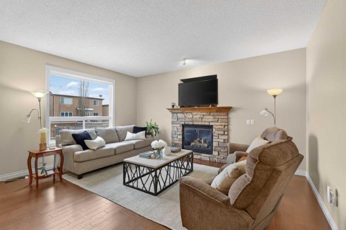 1163 Prairie Springs Hill Sw, Airdrie, AB - Indoor Photo Showing Living Room With Fireplace
