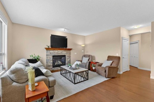 1163 Prairie Springs Hill Sw, Airdrie, AB - Indoor Photo Showing Living Room With Fireplace