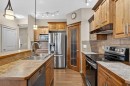 1163 Prairie Springs Hill Sw, Airdrie, AB  - Indoor Photo Showing Kitchen With Double Sink With Upgraded Kitchen 