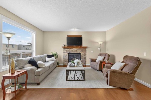 1163 Prairie Springs Hill Sw, Airdrie, AB - Indoor Photo Showing Living Room With Fireplace