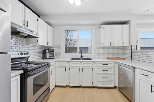 16 Cedarwood Rise Sw, Calgary, AB - Indoor Photo Showing Kitchen With Double Sink