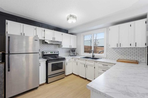 16 Cedarwood Rise Sw, Calgary, AB - Indoor Photo Showing Kitchen With Double Sink