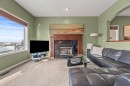 153 Crestridge Way Sw, Calgary, AB  - Indoor Photo Showing Living Room With Fireplace 
