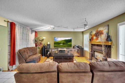 166 Somerset Drive Sw, Calgary, AB - Indoor Photo Showing Living Room With Fireplace