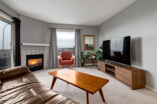 3313-20 Harvest Rose Park Ne, Calgary, AB - Indoor Photo Showing Living Room With Fireplace