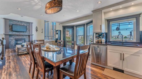 155 Coral Shores Landing Ne, Calgary, AB - Indoor Photo Showing Dining Room With Fireplace