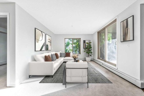 9113-403 Mackenzie Way Sw, Airdrie, AB - Indoor Photo Showing Living Room