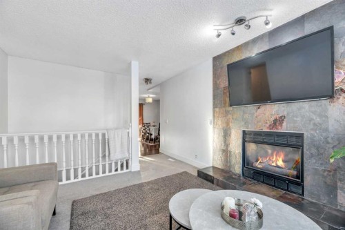 19 Castlepark Way Ne, Calgary, AB - Indoor Photo Showing Living Room With Fireplace