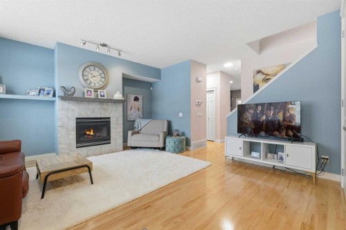 45 Somme Boulevard Sw, Calgary, AB - Indoor Photo Showing Living Room With Fireplace