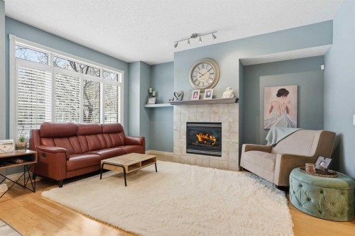 45 Somme Boulevard Sw, Calgary, AB - Indoor Photo Showing Living Room With Fireplace