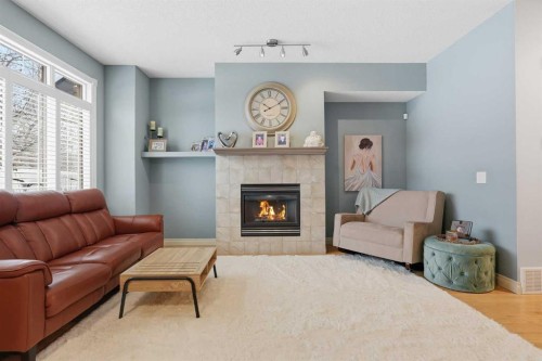 45 Somme Boulevard Sw, Calgary, AB - Indoor Photo Showing Living Room With Fireplace
