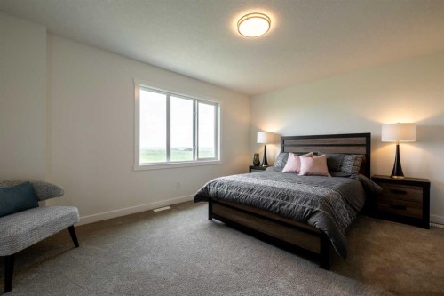 67 Heritage Manor, Cochrane, AB - Indoor Photo Showing Bedroom