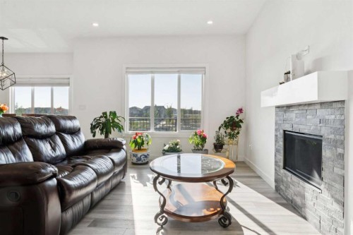 51 Midgrove Drive Sw, Airdrie, AB - Indoor Photo Showing Living Room With Fireplace