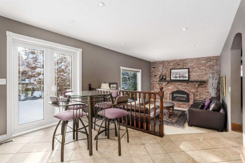 215 Edgemont Place Nw, Calgary, AB - Indoor Photo Showing Dining Room With Fireplace